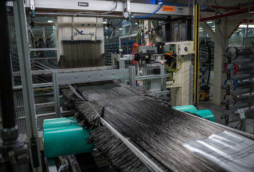 Carbon fiber material being woven for fan blades in Albany Engineered Composites facility.