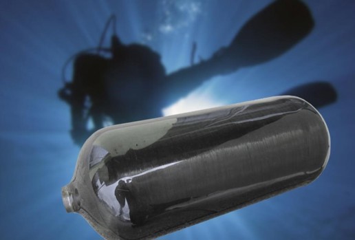 Composite material cylinder with diver silhouette in the background underwater.